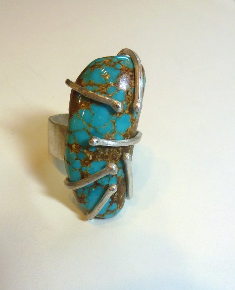 This is an example of modified prong setting made by student, Brighid Lambert. She fabricated this ring out of sterling silver and turquoise. 