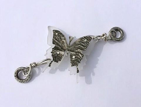 This is an example of riveted overlay made by student, Stephanie Grum. This piece was featured in "100 Links by 100 Artists" jewelry project. Stephanie made this piece out of sterling silver, reticulated silver and acrylic plastic. 