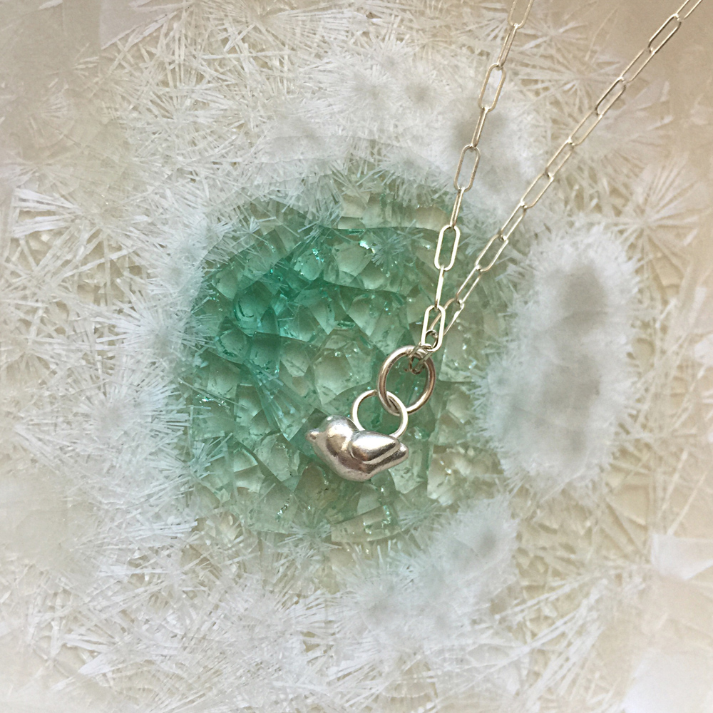My silver baby bird necklace.